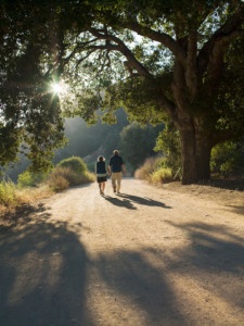 Mature couple walking down dirt road