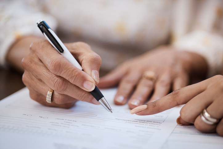Shot of a woman going over her will with an estate planning attorney