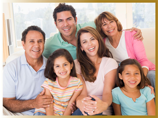 Older middle aged husband and wife with their young adult son, daughter-in-law, and two granddaughters.