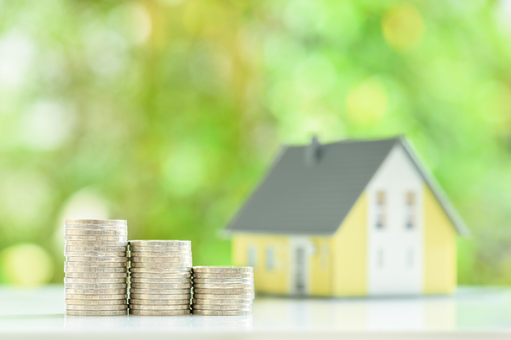 Estate planning lawyer concept: One-story model house on a wood floor, depicting a buyer purchases a residential asset to live and invest for personal gain.